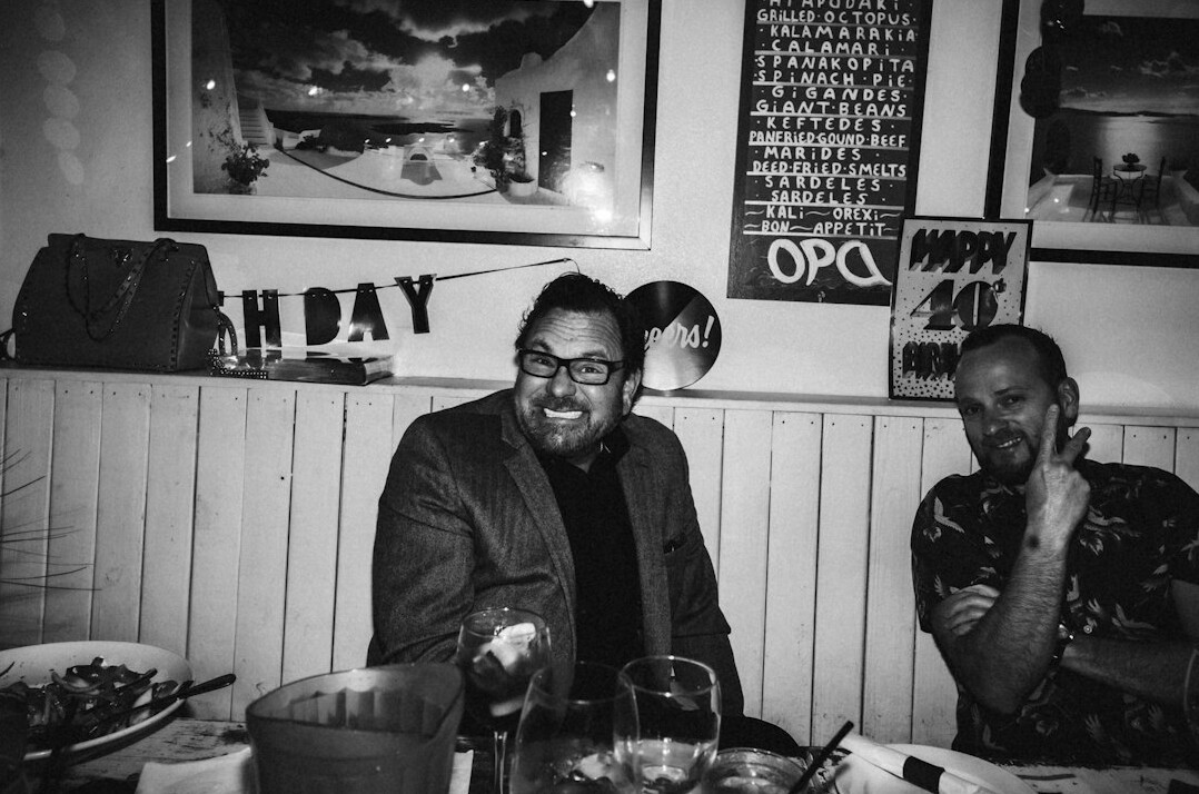 Editorial team of a TV magazine laughing together around a table