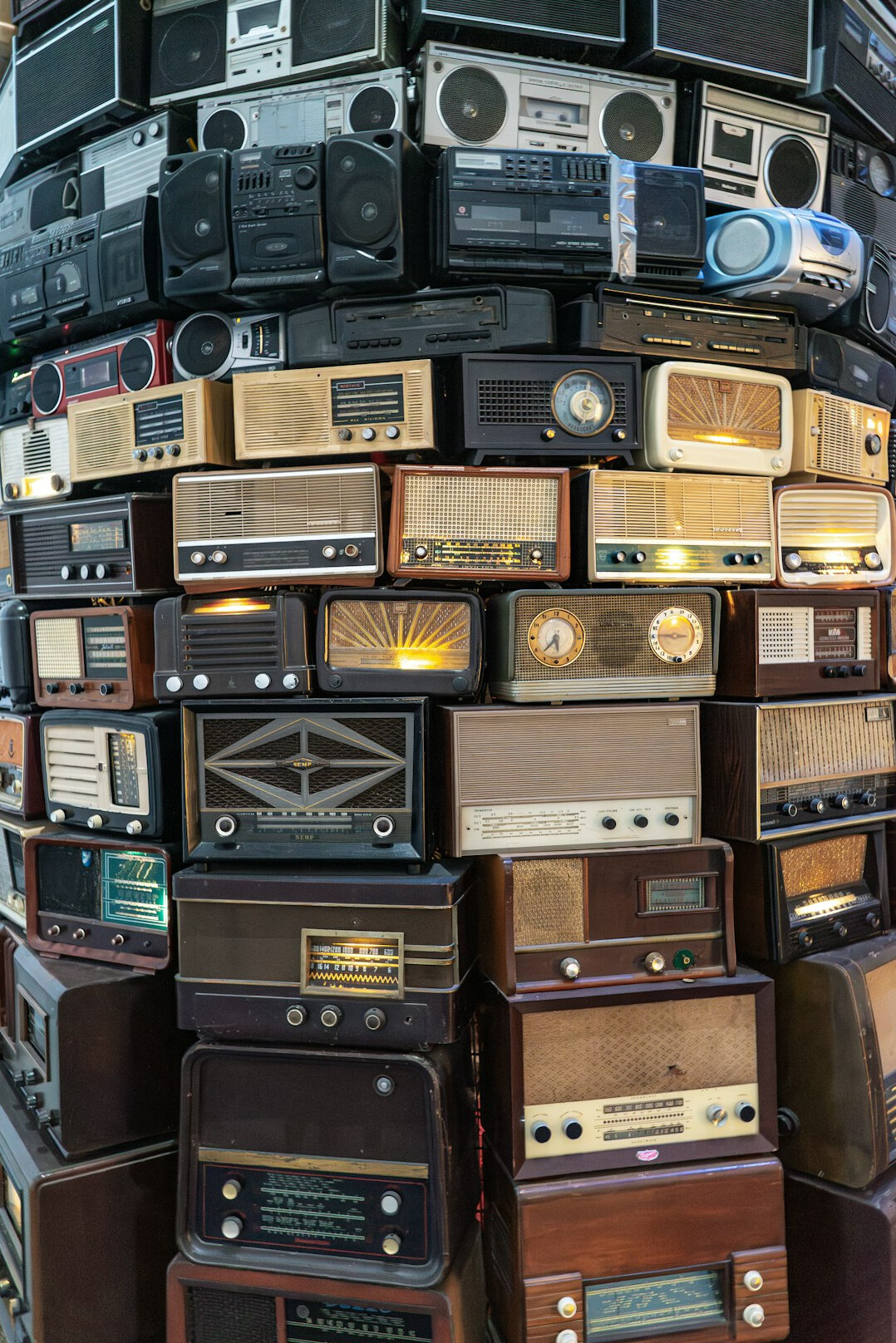 Stack of vintage cathode ray tube televisions showing colour bars